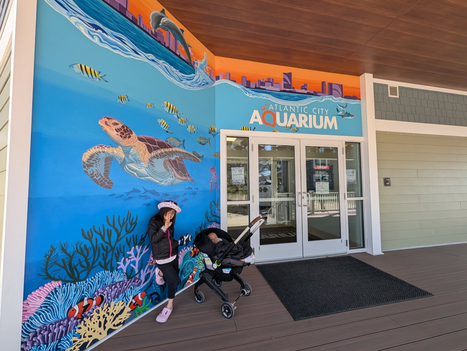Charlotte and Parker in front of the Atlantic City Aquarium entrance mural