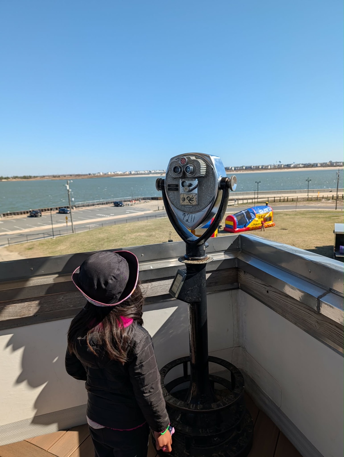 Charlotte looking through viewfinder on the aquarium observation deck