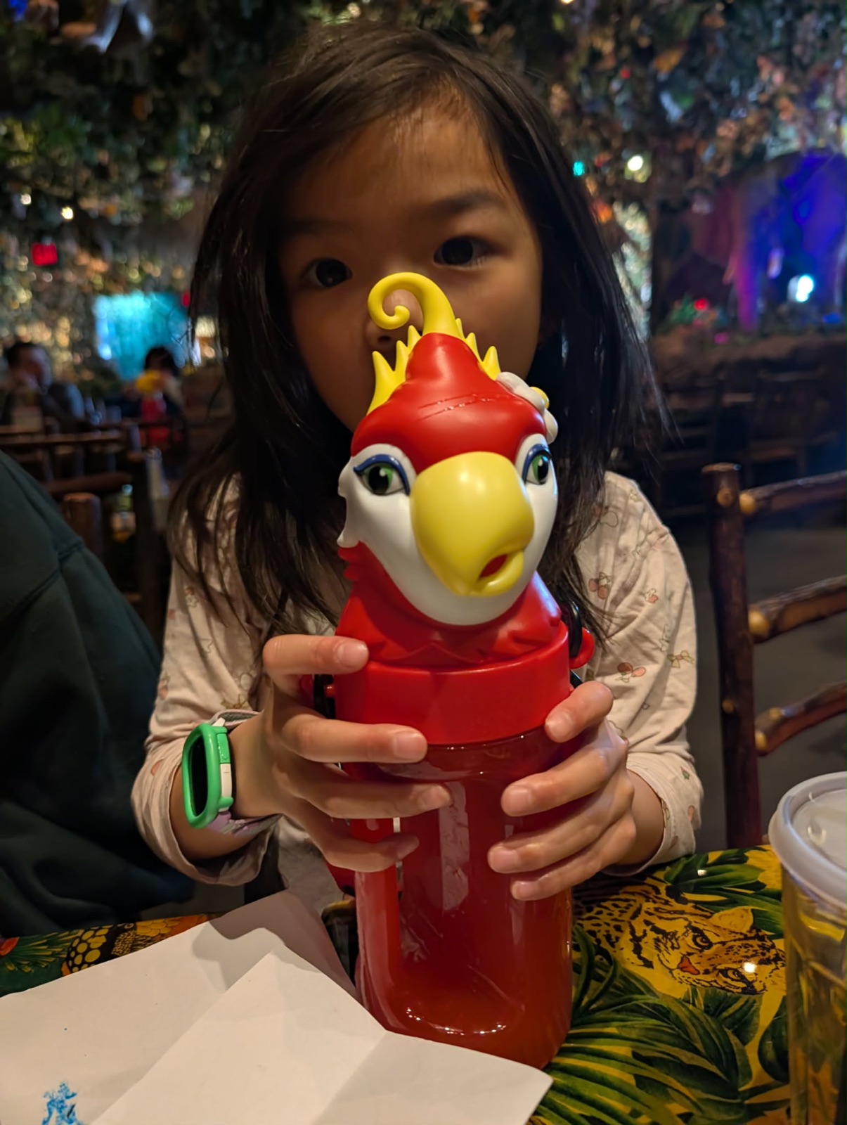 Charlotte holding a Rainforest Cafe mascot bottle with strawberry lemonade