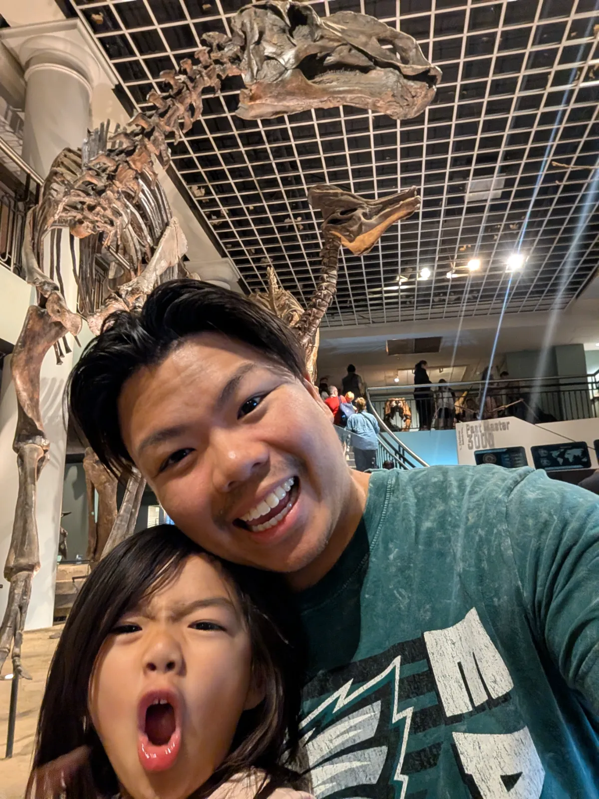 Family selfie with a dinosaur skeleton at the Academy of Natural Sciences