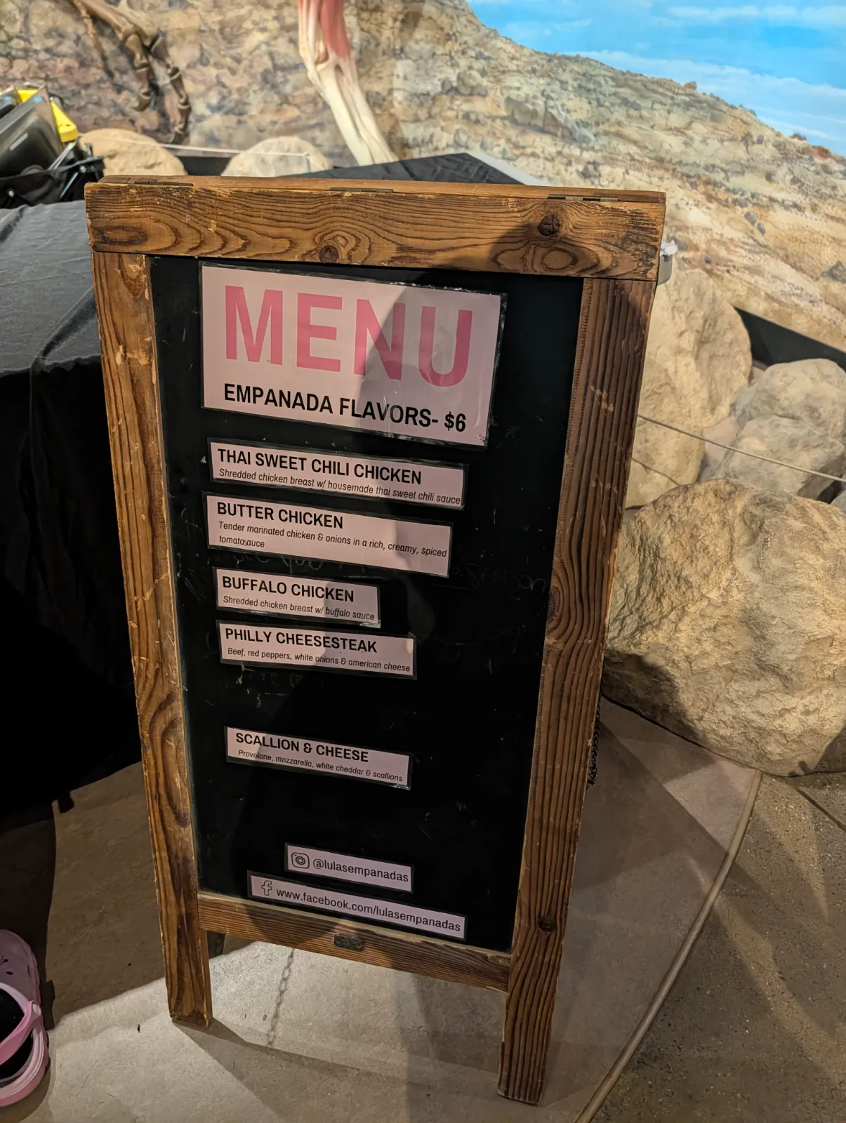 Chalkboard menu showing empanada flavors at $6 each