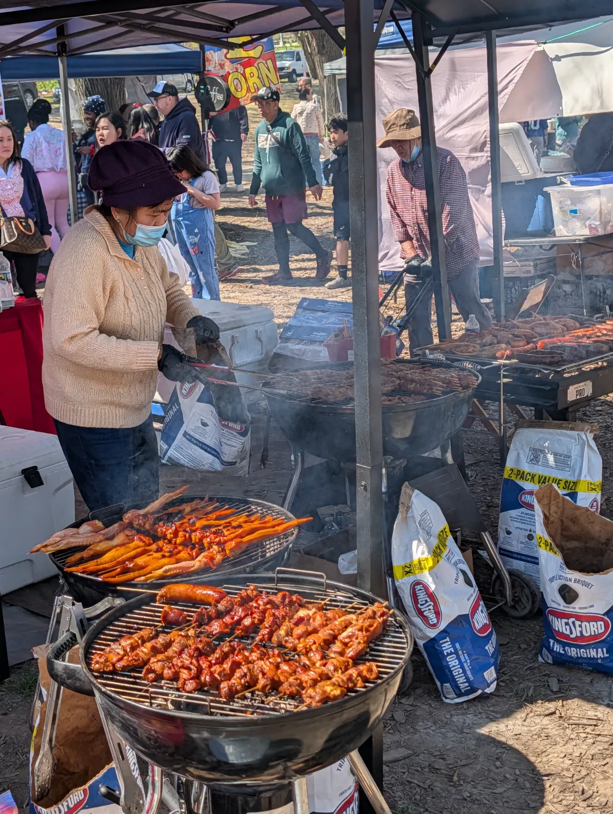 Meat being grilled over charcoal