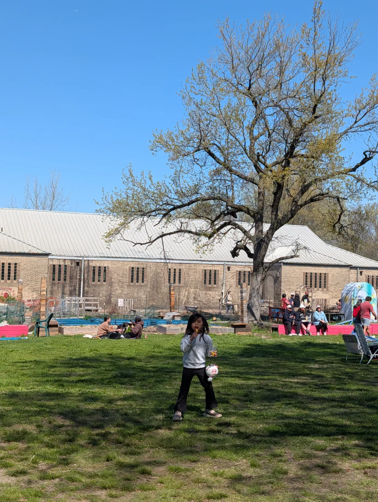 Charlotte standing in front of the open lawn picnic area at FDR Park