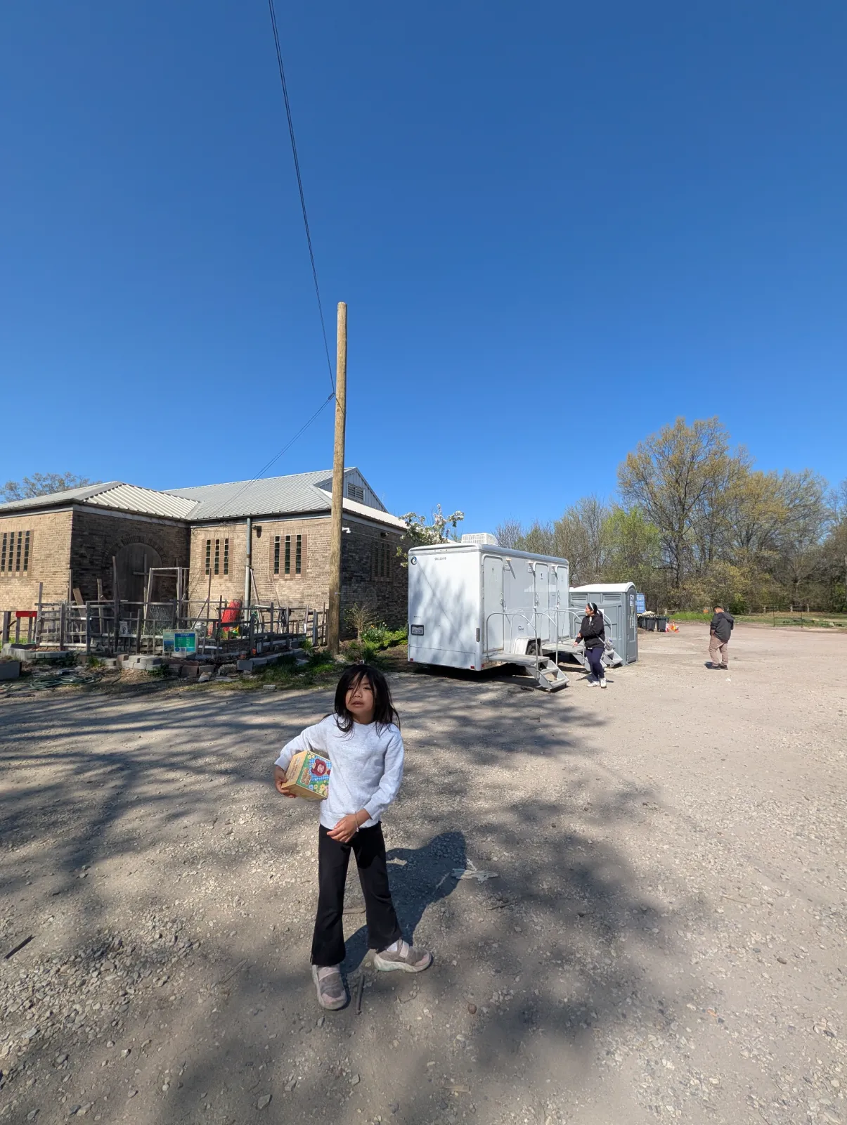 Locked bathroom trailers at the Southeast Asian Market with green available lights