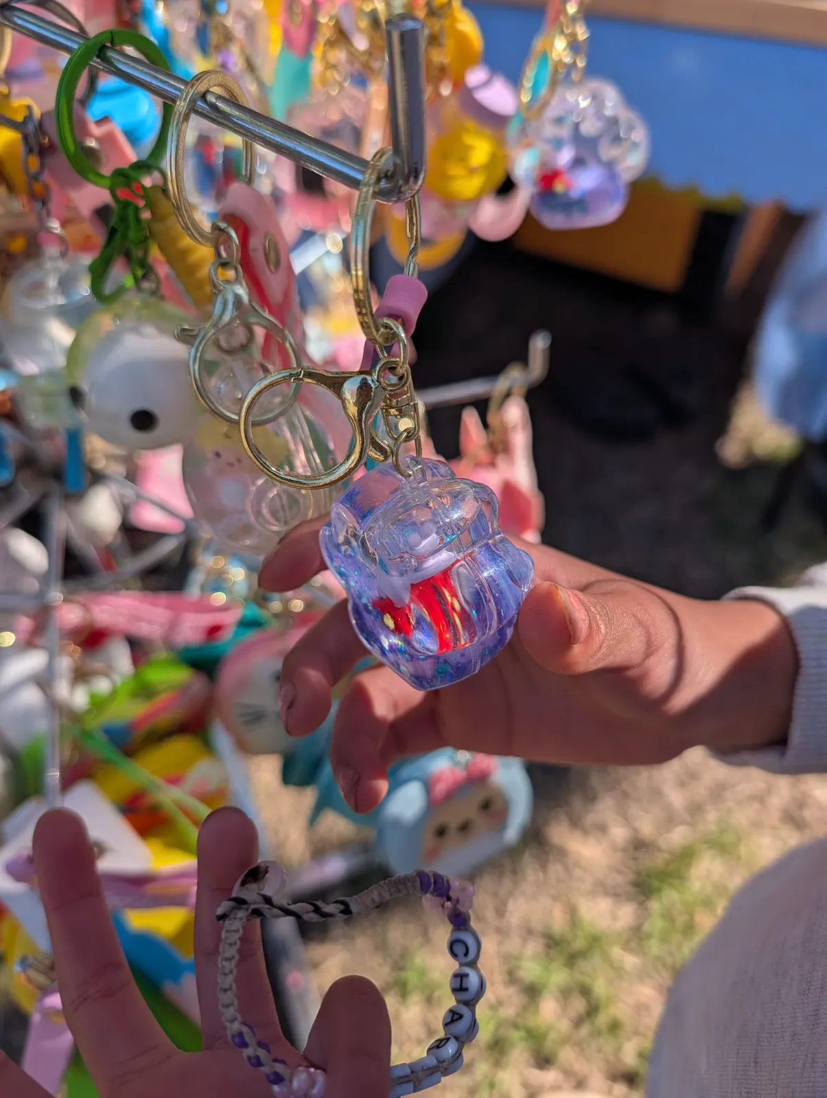 Keychains and toys on display at a vendor table