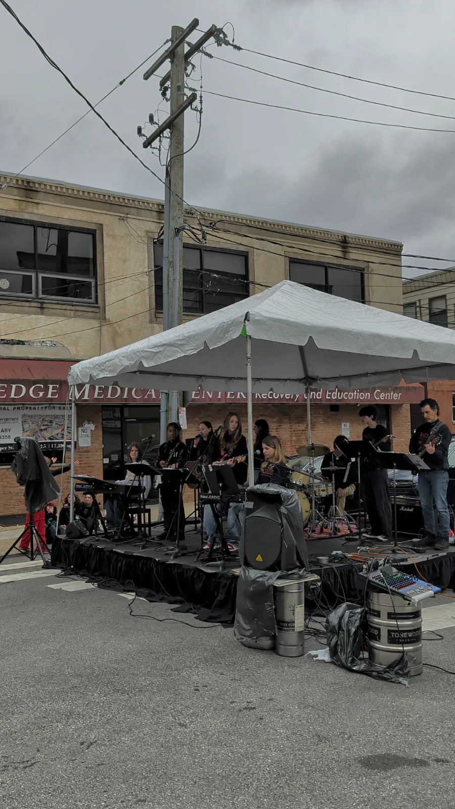 A local band performing under a tent at Flavors on the Avenue