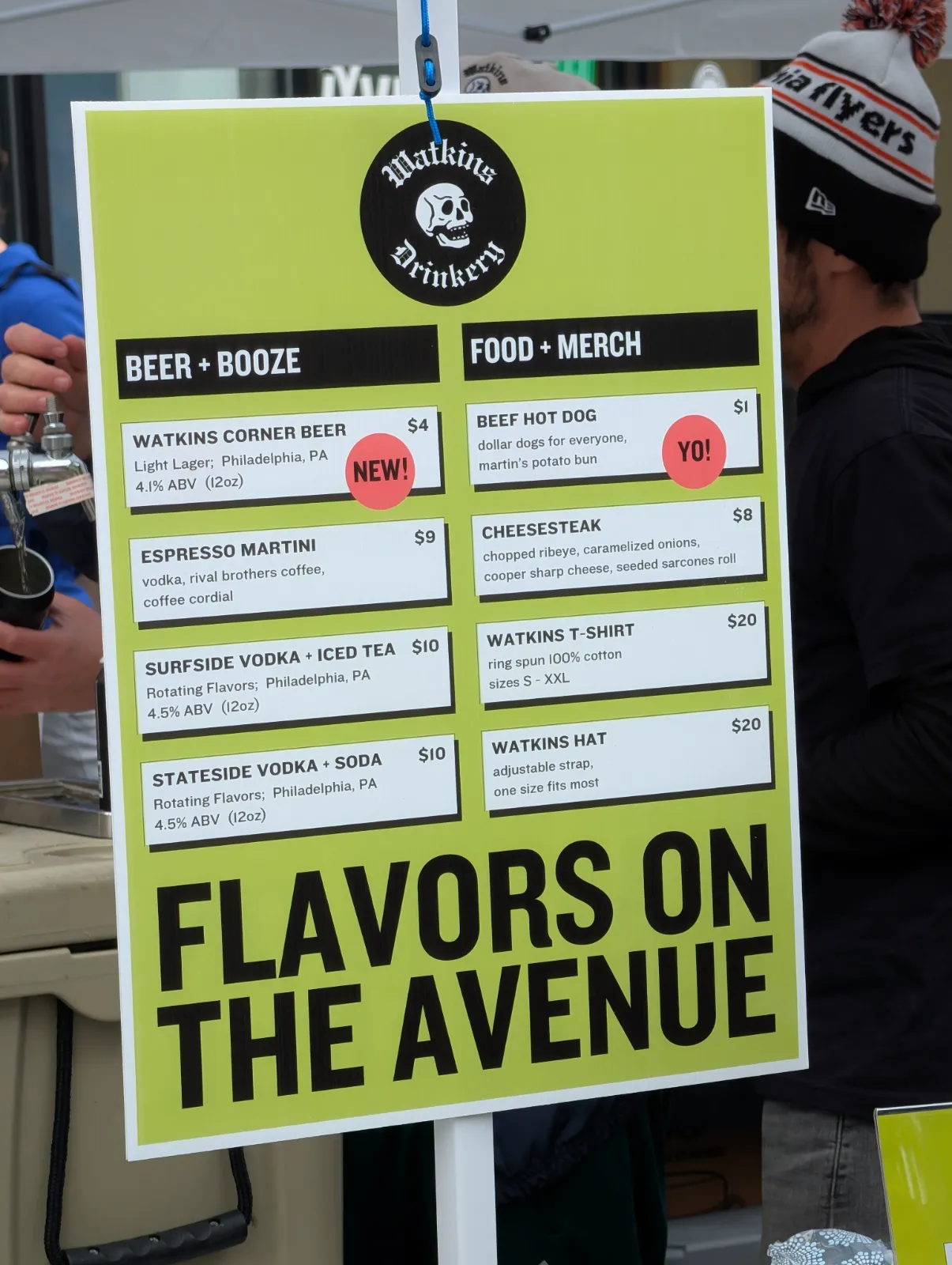 Watkins Drinkery menu board showing beers, cocktails, and food options at Flavors on the Avenue