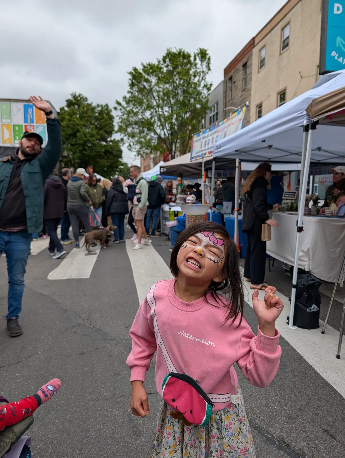 Charlotte grinning with colorful face paint at Flavors on the Avenue on East Passyunk