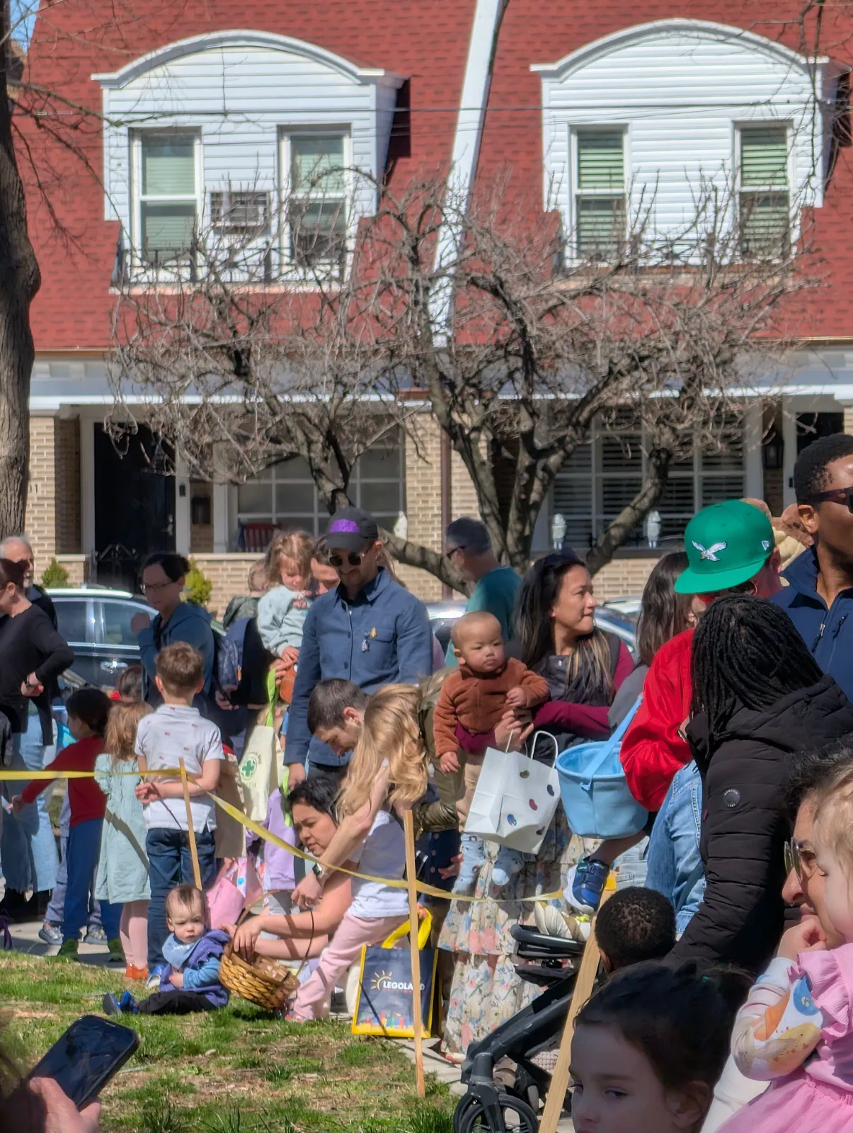 Families and children at a community Easter egg hunt in a Philadelphia neighborhood