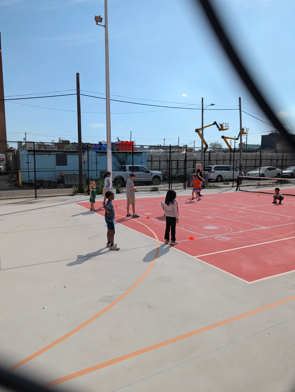 Charlotte doing drills at red ball camp on the smaller court