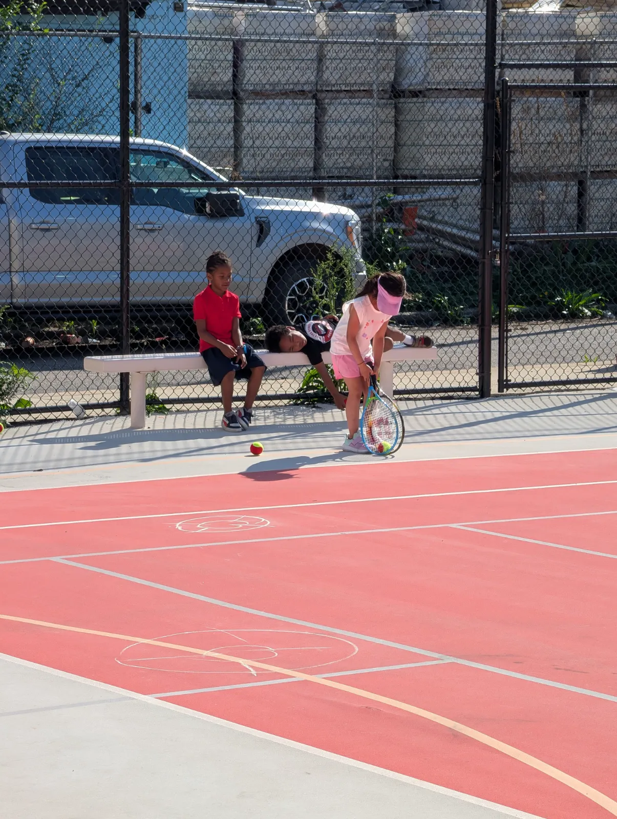Charlotte wearing her sun visor at tennis camp