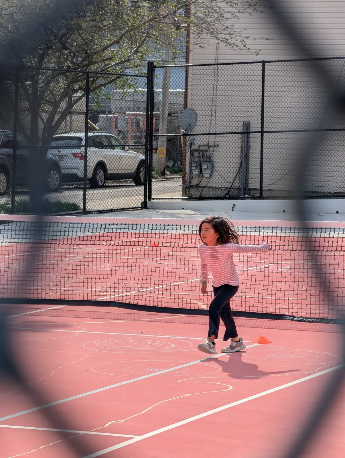 Charlotte in her tennis outfit ready for camp