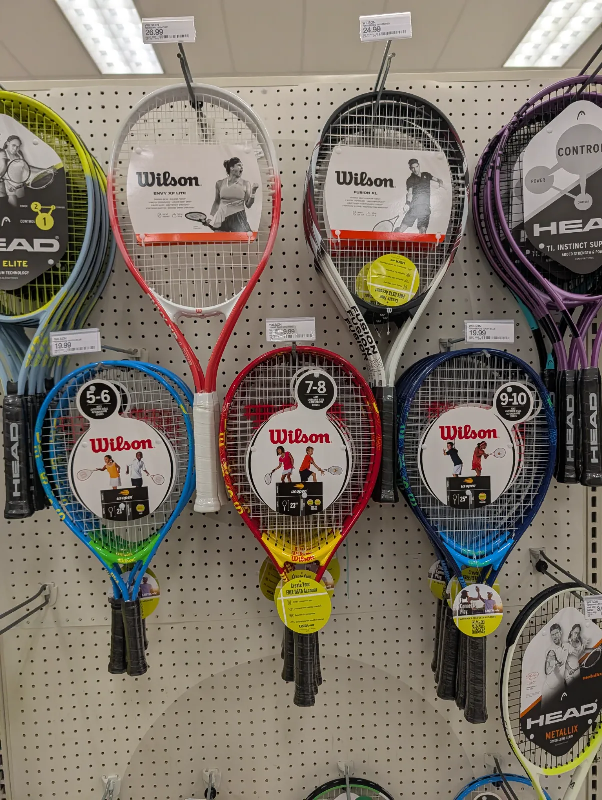 The Wilson junior racket on a Target shelf alongside other racquets