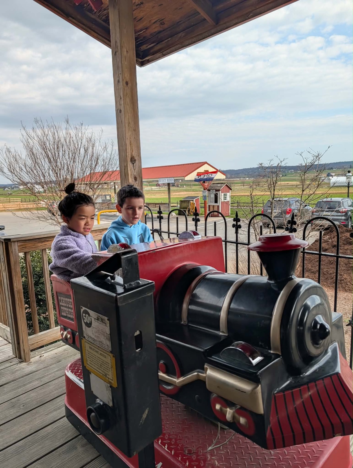 Charlotte and friend on the outdoor train ride at Red Caboose
