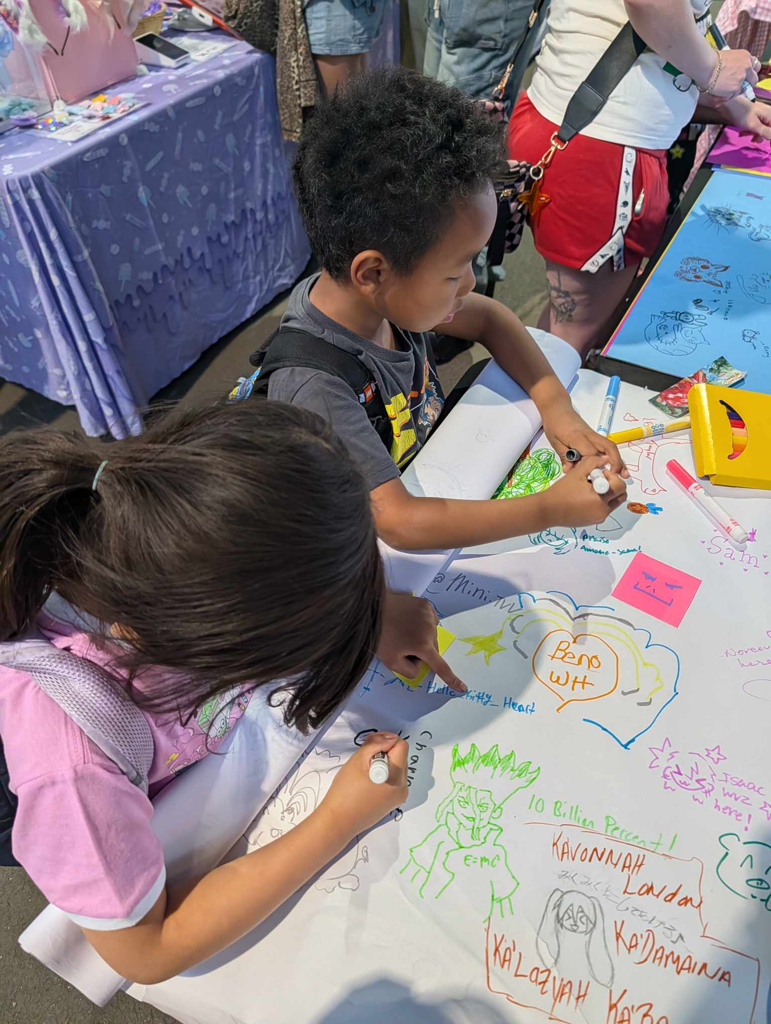 Kids drawing at the open-ended drawing station