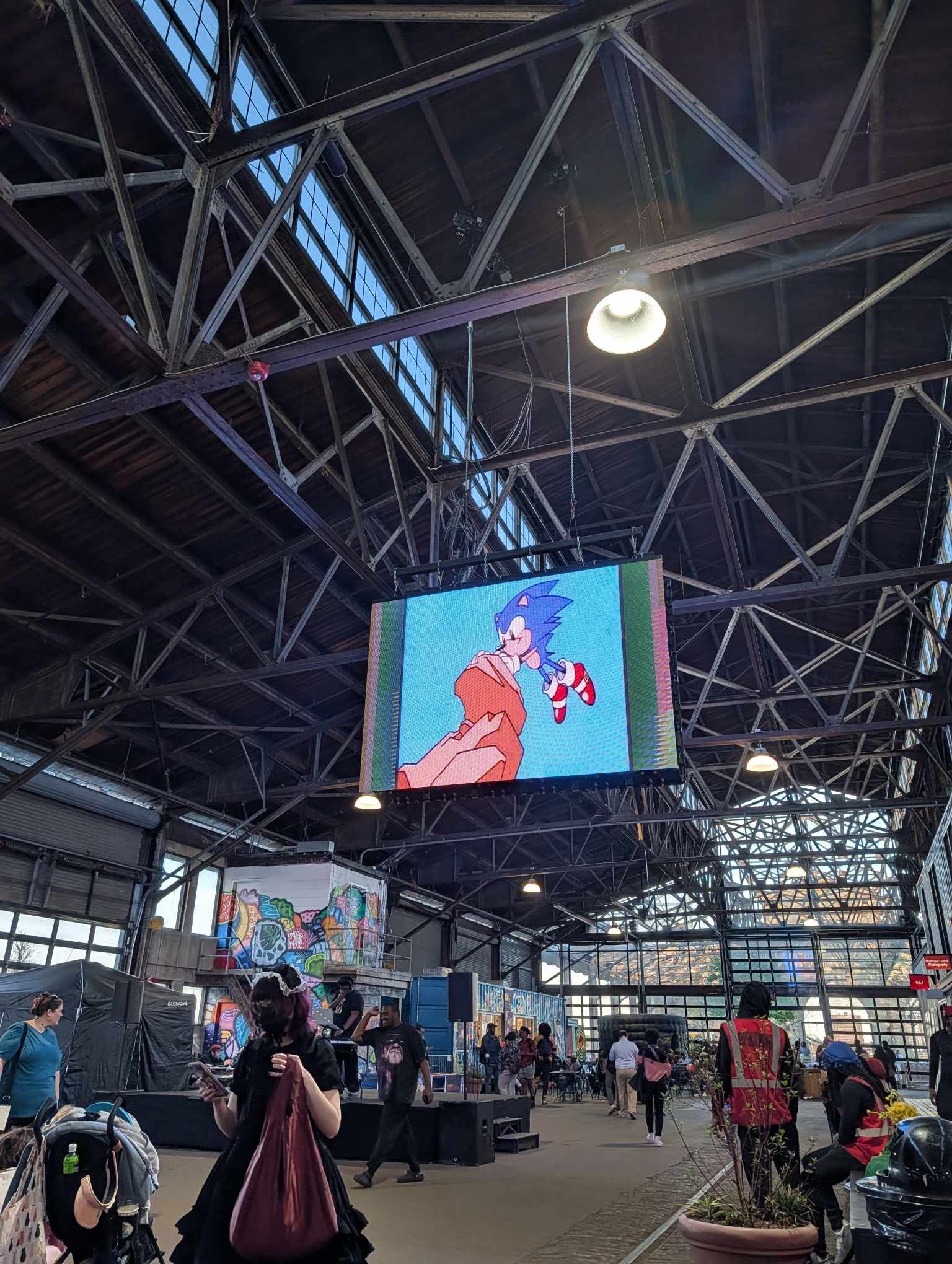 DJ spinning with anime graphics on screen