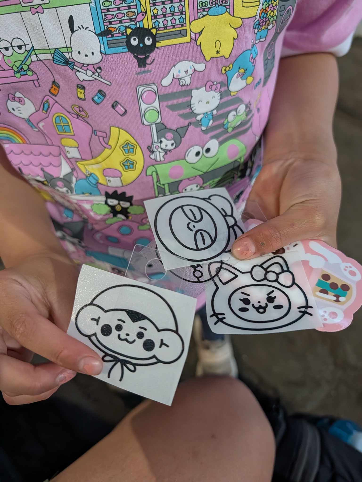 Charlotte picking out car decals at a vendor booth