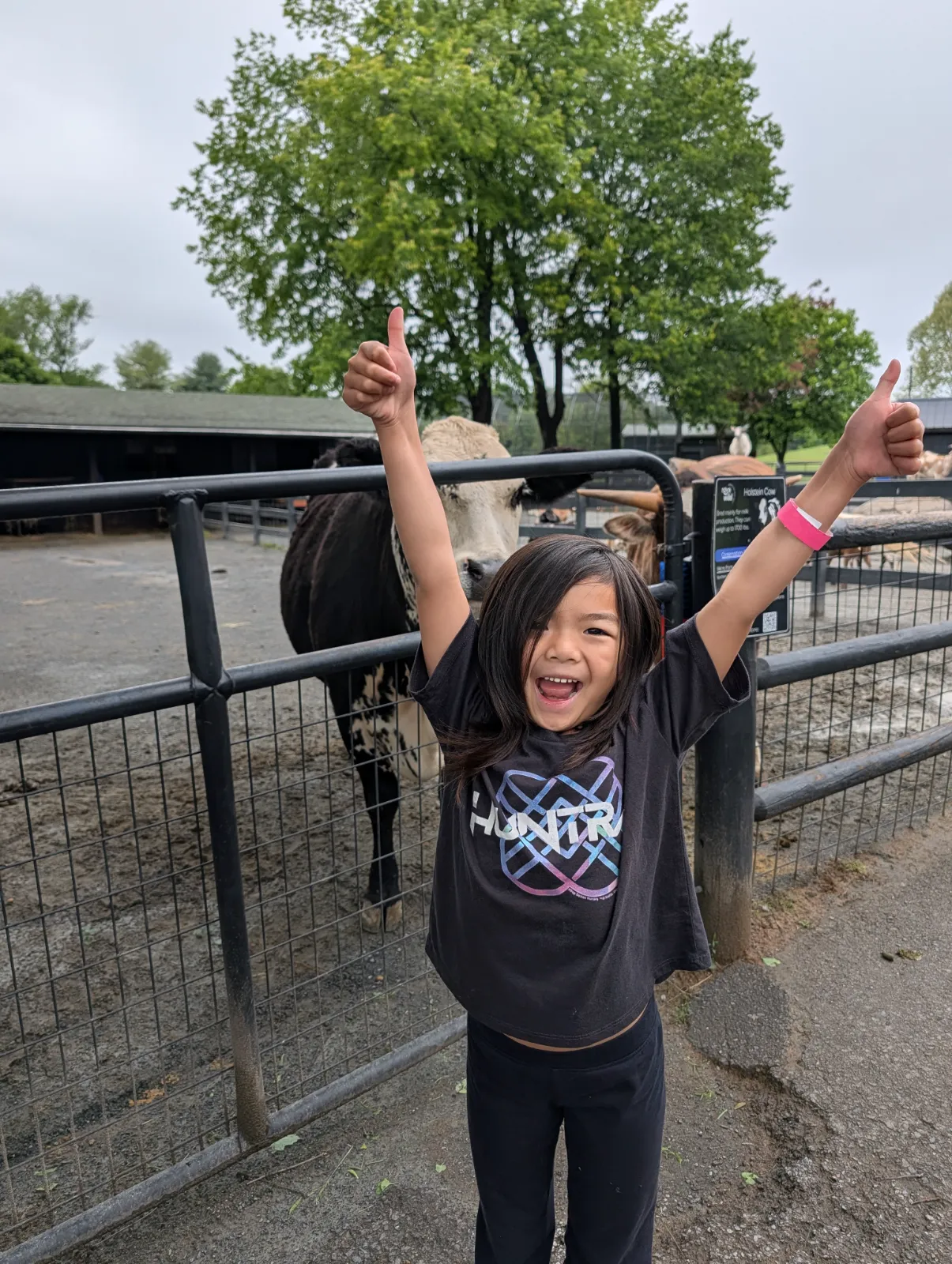 Charlotte giving a thumbs up in front of cows at Nova Wild