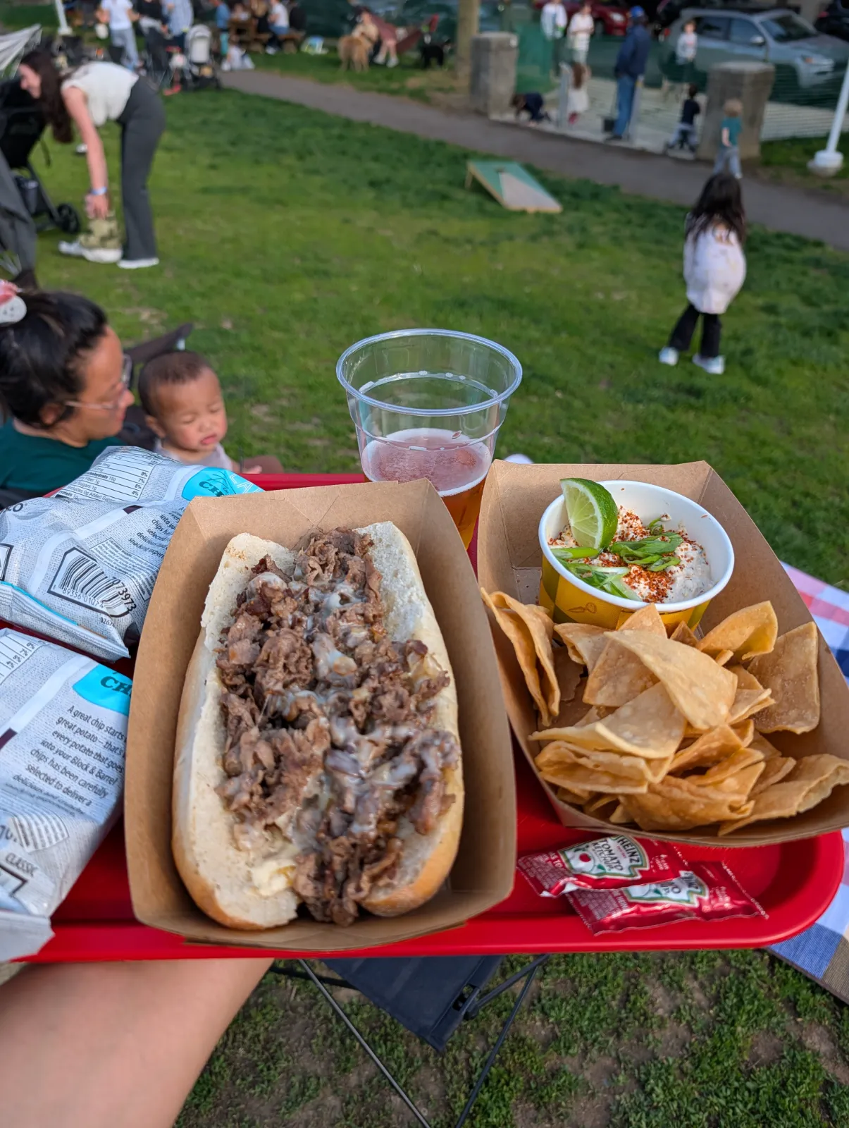 Cheesesteak and snacks spread out on a table at Parks on Tap