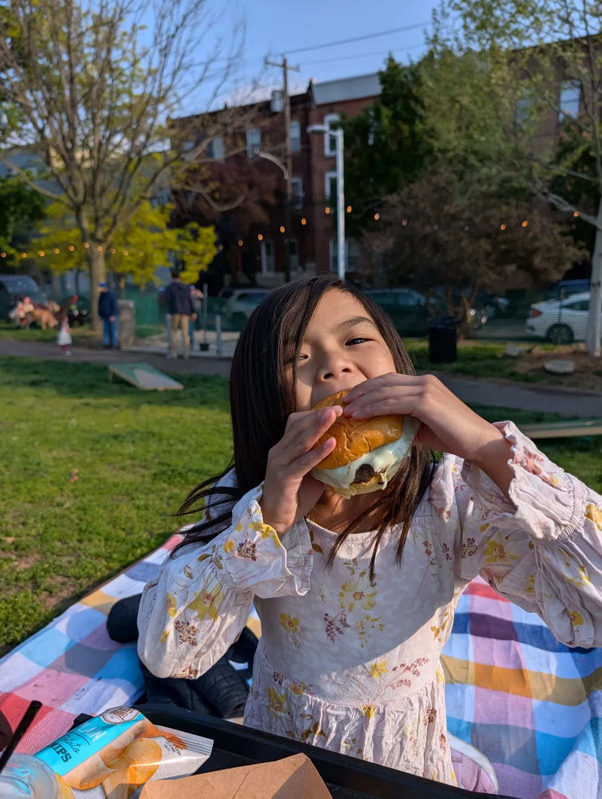 Charlotte eating a burger at Parks on Tap in Columbus Square