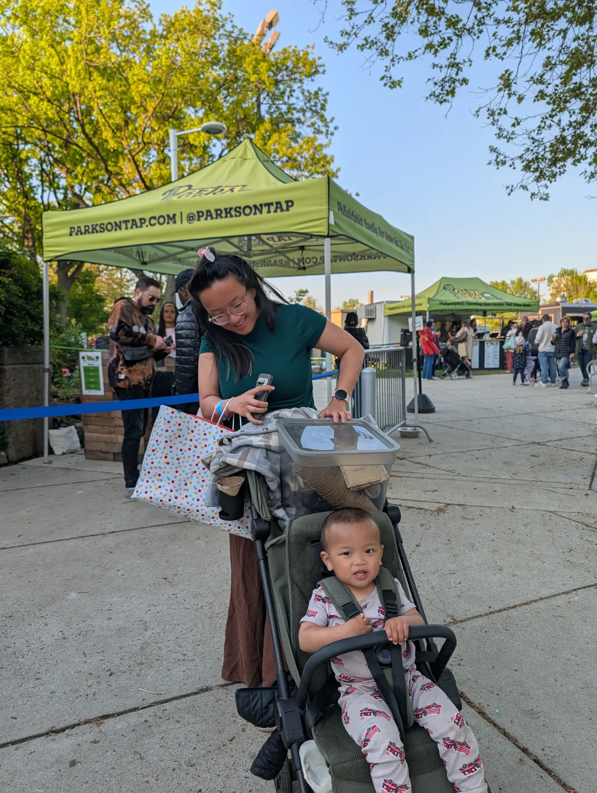 A mother and child in a stroller entering Parks on Tap at Columbus Square
