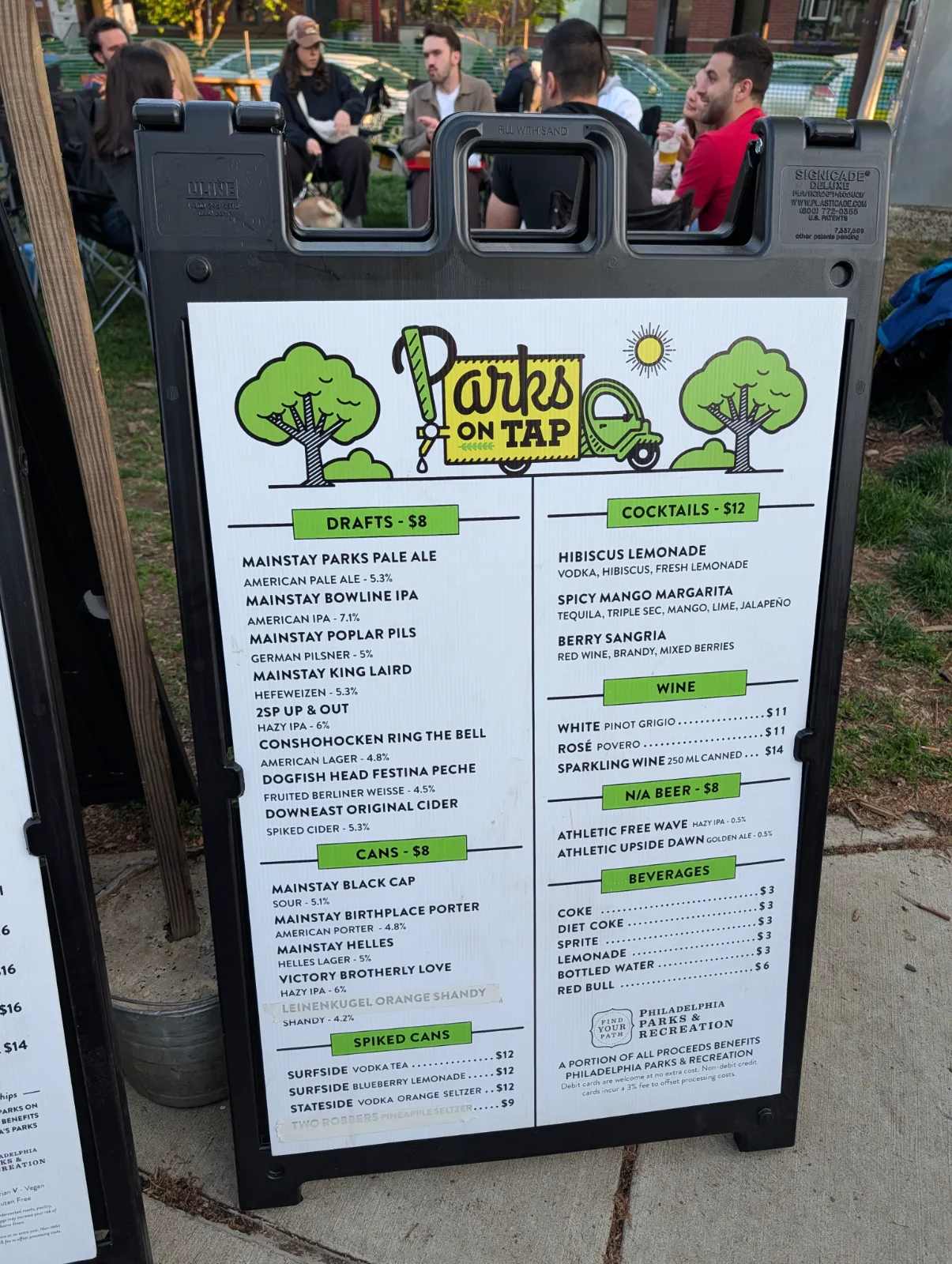 Outdoor drink menu board at Parks on Tap showing draft beers, cocktails, and non-alcoholic options