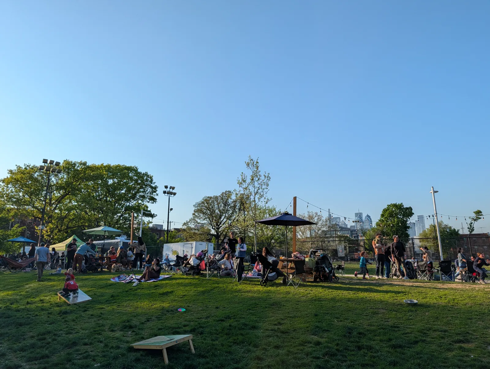 Lively park scene with families enjoying a sunny day at Parks on Tap