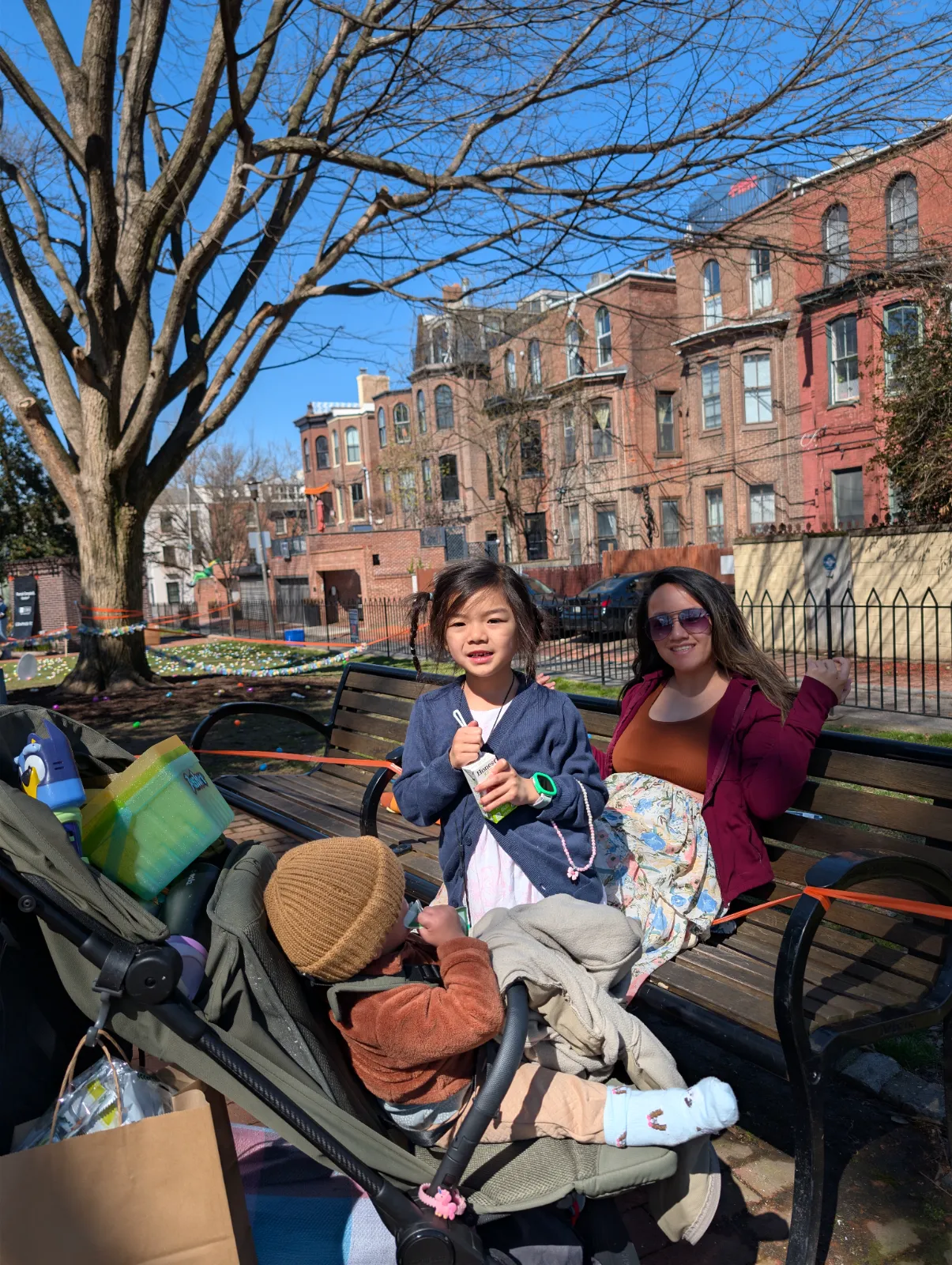 A mother and children enjoying family time at the park during a spring event