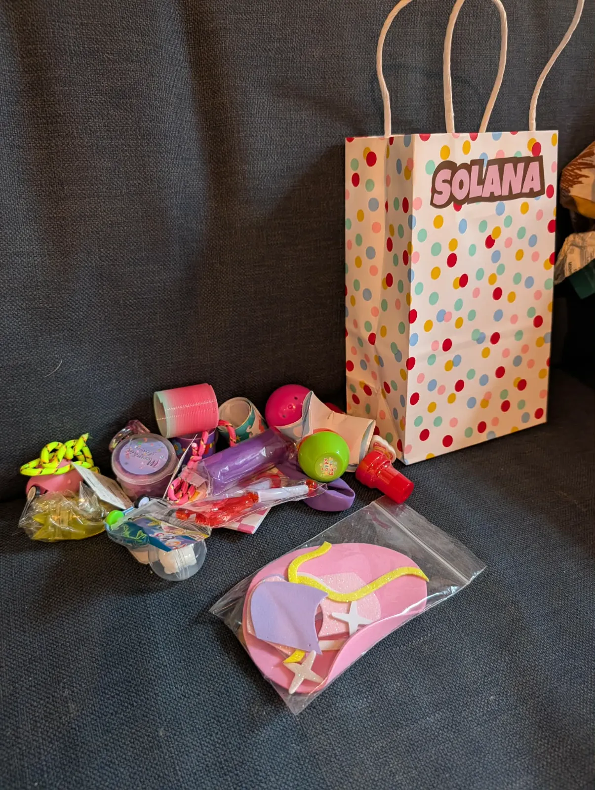 Assortment of party favors and small toys laid out for stuffing Easter eggs