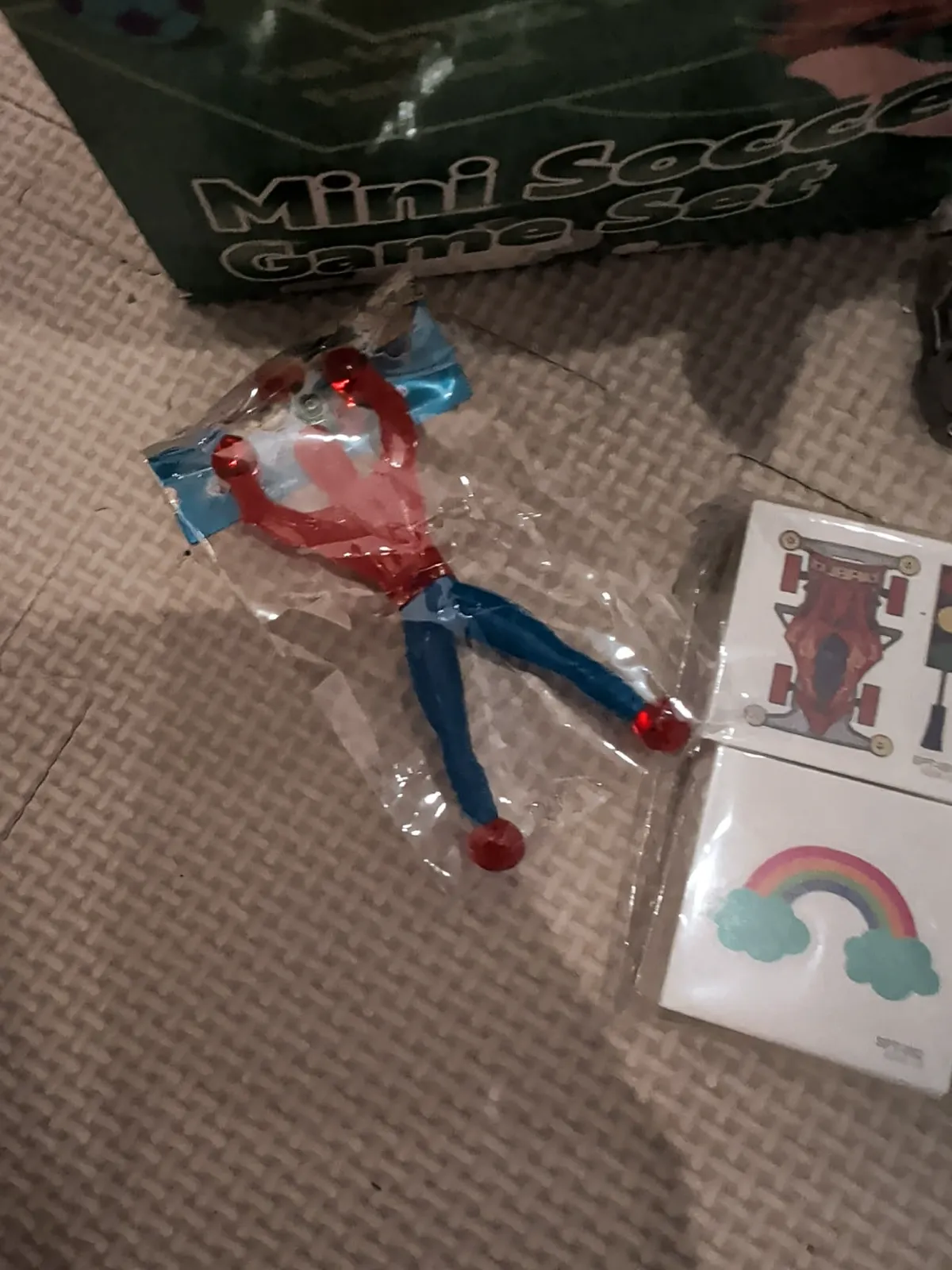 Packaged toy figure and fun stickers with mini soccer game set in background