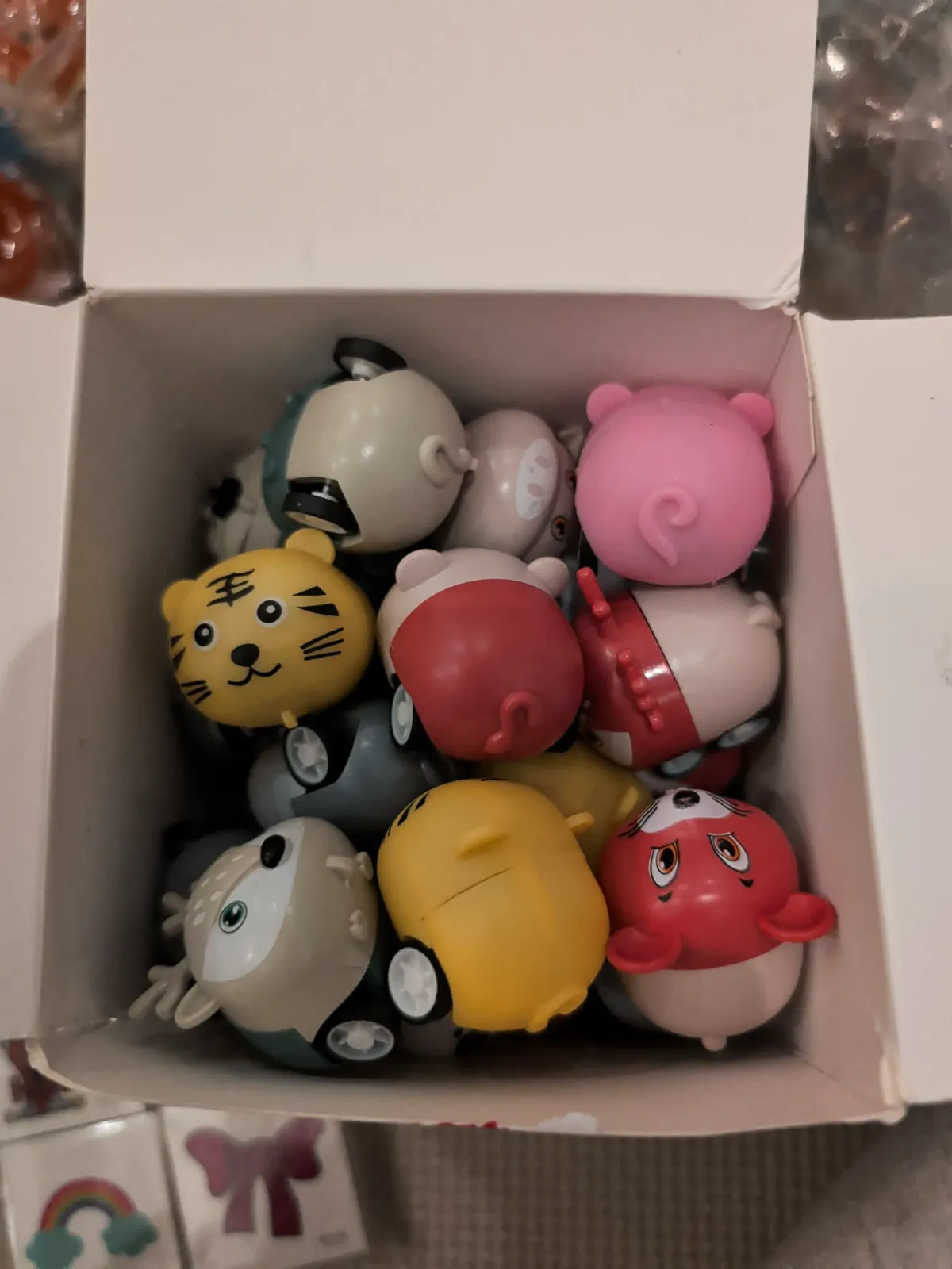 Box of cute animal figurines in vibrant colors