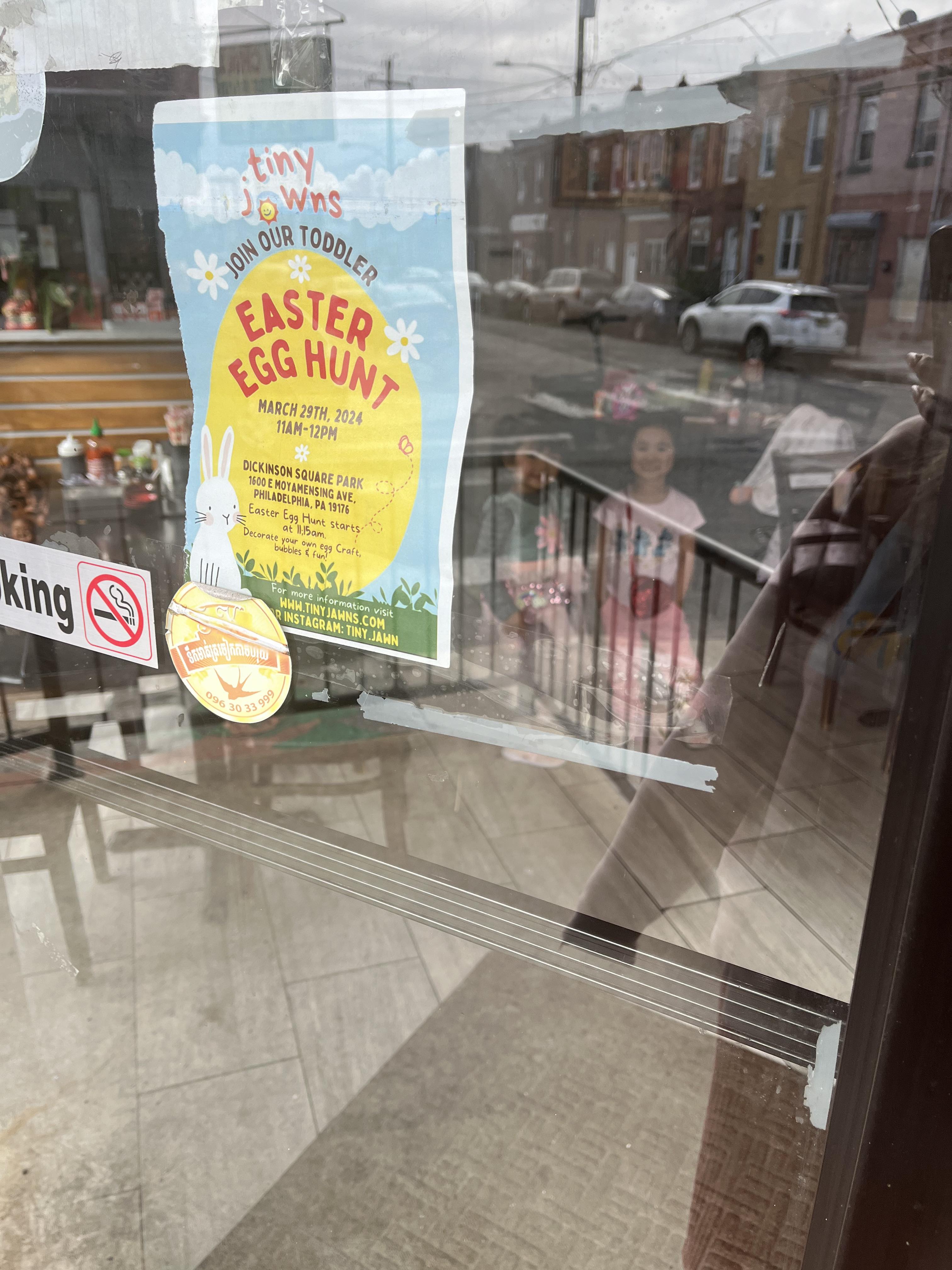 TinyJawns Easter Egg Hunt flyer posted in a South Philly storefront window