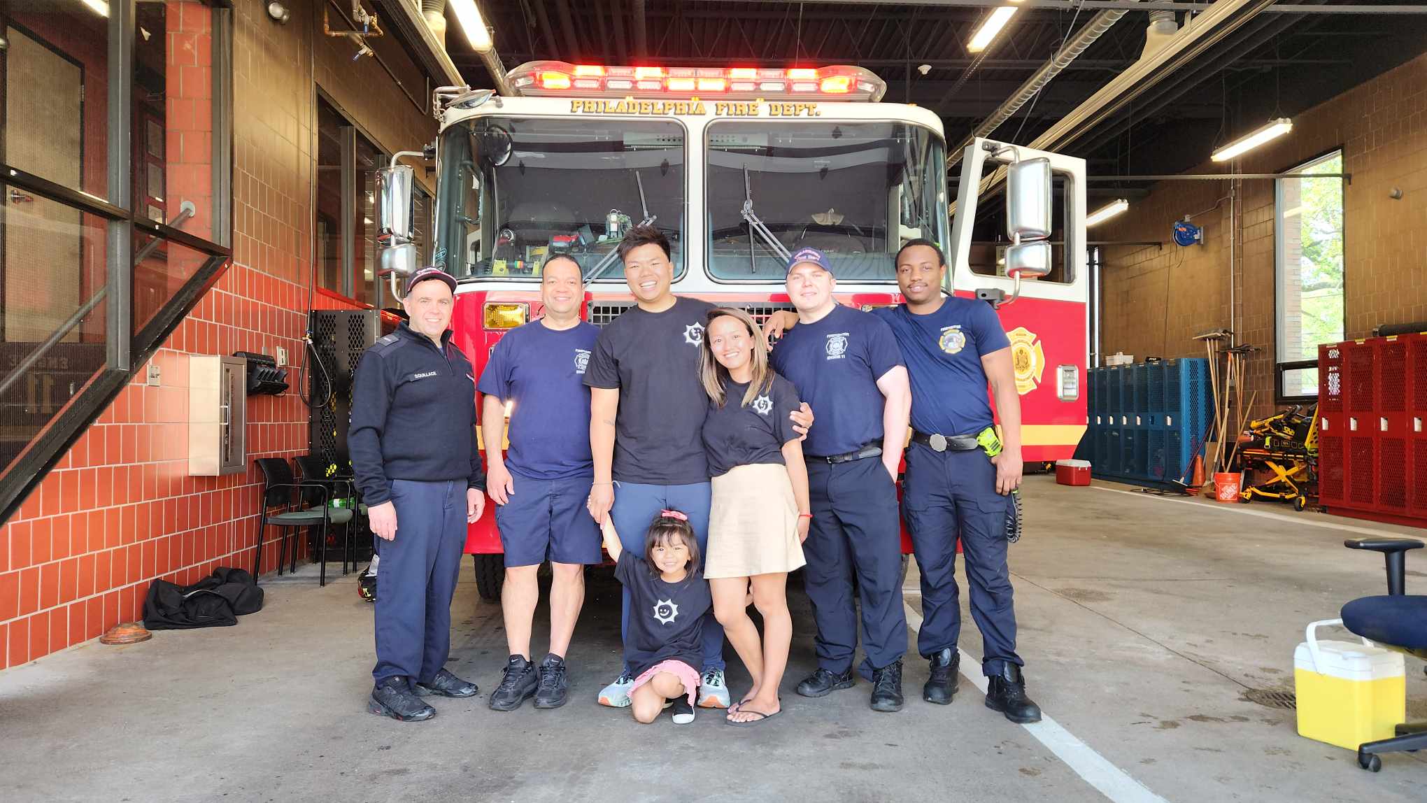 Brandon, Abby, and Charlotte with Philadelphia firefighters at the TinyJawns firefighter event